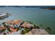 Expansive waterfront property featuring a private dock, lush landscaping, and serene bay views at 11697 Grove St, Seminole, FL 33772