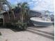 Exterior view of home with boat, palm trees, and beautiful stone walkway at 11697 Grove St, Seminole, FL 33772