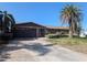 Inviting single-story home with brick details, lush landscaping, and a spacious driveway at 11697 Grove St, Seminole, FL 33772