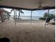 Covered patio area with brick floors overlooking the beautiful waterfront at 11697 Grove St, Seminole, FL 33772