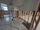 Room under construction featuring tile floors and open stud walls at 11697 Grove St, Seminole, FL 33772