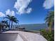 Beautiful waterfront property with boat dock and palm trees, perfect for bay access at 11697 Grove St, Seminole, FL 33772