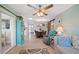 Cozy living area with a ceiling fan, comfortable seating, and a barn door detail at 1303 Glengarry Dr, Palm Harbor, FL 34684