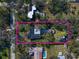 An aerial shot of the property featuring a pool, fenced yard, outdoor lounge, and a well-maintained exterior at 13225 108Th Ave, Largo, FL 33774