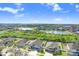 Stunning aerial view of a neighborhood with beautiful homes, a tranquil lake, and lush greenery at 13235 Graham Yarden Dr, Riverview, FL 33579