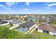 Aerial view of a home with a screened pool and fenced yard in a well-maintained neighborhood near a pond at 13235 Graham Yarden Dr, Riverview, FL 33579