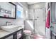 Bright bathroom featuring a modern vanity, a stylish sink, and a walk-in shower with glass door at 13235 Graham Yarden Dr, Riverview, FL 33579