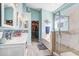 Stylish bathroom with double sinks, walk-in shower, soaking tub, and walk-in closet at 13235 Graham Yarden Dr, Riverview, FL 33579