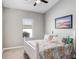 Well-lit bedroom with a charming bed, neutral walls, and a delightful nautical themed decor at 13235 Graham Yarden Dr, Riverview, FL 33579