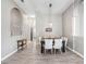 Formal dining area featuring modern lighting, neutral décor, and hardwood-style floors at 13235 Graham Yarden Dr, Riverview, FL 33579