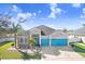 Charming single-Gathering home featuring a three-car garage and eye-catching turquoise doors at 13235 Graham Yarden Dr, Riverview, FL 33579