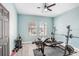 Home gym featuring modern exercise equipment and ample natural light from two windows at 13235 Graham Yarden Dr, Riverview, FL 33579