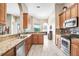 Well-lit kitchen featuring granite countertops, stainless steel appliances, and wood cabinetry at 13235 Graham Yarden Dr, Riverview, FL 33579