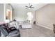Spacious living room with gray wood floors and modern furniture, perfect for relaxation at 13235 Graham Yarden Dr, Riverview, FL 33579