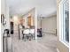 Open concept living room with kitchen bar seating, ceiling fan, and modern gray flooring at 13235 Graham Yarden Dr, Riverview, FL 33579