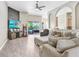 Comfortable living room with ceiling fan, stylish decor, and sliding doors to the outdoor area at 13235 Graham Yarden Dr, Riverview, FL 33579