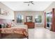 Bright main bedroom with ceiling fan, dresser, and sliding glass doors to outdoor area at 13235 Graham Yarden Dr, Riverview, FL 33579