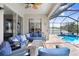 Inviting screened patio with comfortable seating and a view of the sparkling pool and jacuzzi at 13235 Graham Yarden Dr, Riverview, FL 33579