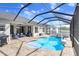 Beautiful backyard featuring a sparkling pool, jacuzzi, and a comfortable seating area for relaxing at 13235 Graham Yarden Dr, Riverview, FL 33579