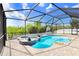 Gorgeous pool area with a spa, rock waterfall feature, and a basketball hoop for outdoor fun at 13235 Graham Yarden Dr, Riverview, FL 33579