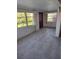 Bright living room with tile floor and large windows bringing in natural light at 14034 Marguerite Dr, Madeira Beach, FL 33708