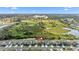 The aerial shot shows the proximity to a large commercial building and surrounding wetlands at 1454 Tahitian Sunrise Dr, Plant City, FL 33565