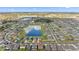 Aerial view of a residential community featuring a lake and well-maintained streets at 1454 Tahitian Sunrise Dr, Plant City, FL 33565