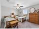 This bedroom features a window, ceiling fan, wooden furniture, and carpet flooring at 1454 Tahitian Sunrise Dr, Plant City, FL 33565