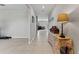 Inviting hallway with light tile flooring and a view into the living area at 1454 Tahitian Sunrise Dr, Plant City, FL 33565