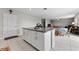 Open kitchen island with seating area and view of the dining and living spaces at 1454 Tahitian Sunrise Dr, Plant City, FL 33565