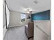 Cozy loft area with neutral carpeting, a large screen and a ceiling fan at 1454 Tahitian Sunrise Dr, Plant City, FL 33565
