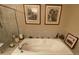 Bathroom featuring a large soaking tub, tile, and art work at 15 Jefferson S Ct, St Petersburg, FL 33711