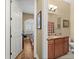 Bathroom vanity, granite countertop with sink and wood cabinet, seen through doorway at 15 Jefferson S Ct, St Petersburg, FL 33711