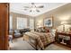 Cozy bedroom featuring a ceiling fan, plush bed, and natural light from the windows at 15 Jefferson S Ct, St Petersburg, FL 33711