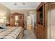 Bedroom featuring wood flooring, a large bed, wood furniture, and an archway at 15 Jefferson S Ct, St Petersburg, FL 33711