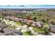 An aerial view of the neighborhood with multiple homes, close to wooded areas and a lake at 16410 Ivy Lake Dr, Odessa, FL 33556