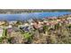 An aerial view shows the home near a lake, surrounded by other properties with pools at 16410 Ivy Lake Dr, Odessa, FL 33556
