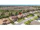 An aerial view of a home and neighborhood surrounded by wooded areas at 16410 Ivy Lake Dr, Odessa, FL 33556