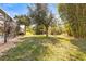 Landscaped backyard with a view of a nearby pool at 16410 Ivy Lake Dr, Odessa, FL 33556