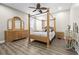 Bedroom featuring ceiling fan, wood floors, and wooden furniture at 16410 Ivy Lake Dr, Odessa, FL 33556