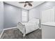 Bedroom featuring carpet, white trim, ceiling fan, and a light and airy feel at 16410 Ivy Lake Dr, Odessa, FL 33556