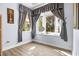 Bright, empty bedroom with a bay window that lets in plenty of natural light and wood-look floors at 16410 Ivy Lake Dr, Odessa, FL 33556