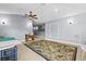 Open bonus room featuring plush carpeting, sconce lighting, and a stylish ceiling fan at 16410 Ivy Lake Dr, Odessa, FL 33556