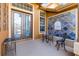 Cozy front porch with stylish seating, a decorative tile wall, and an elegant double door entry at 16410 Ivy Lake Dr, Odessa, FL 33556