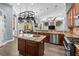 Modern kitchen with granite counters, stainless appliances, pot rack and open floor plan at 16410 Ivy Lake Dr, Odessa, FL 33556