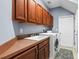 Laundry room with cabinets, sink, countertop, washer, and dryer for convenient chores at 16410 Ivy Lake Dr, Odessa, FL 33556