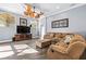 Comfortable living room with wood floors, fan, and plenty of windows at 16410 Ivy Lake Dr, Odessa, FL 33556