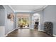 Elegant living room with hardwood floors, pool views, crown molding, and a seamless connection to other spaces at 16410 Ivy Lake Dr, Odessa, FL 33556