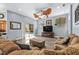 Spacious living room featuring wood floors, fan, and sliding glass doors to the pool at 16410 Ivy Lake Dr, Odessa, FL 33556