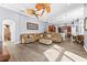 Large living room with wood floors, and open floor plan with a view to the kitchen at 16410 Ivy Lake Dr, Odessa, FL 33556